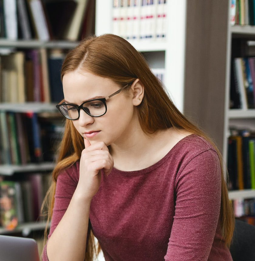 Serious student girl reading science article online